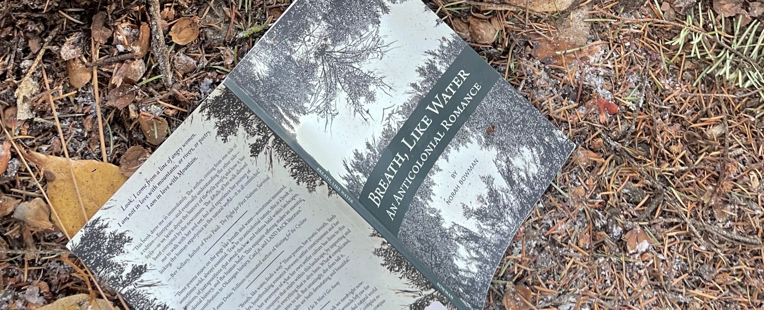 The book Breath, Like Water, sits open on the ground.