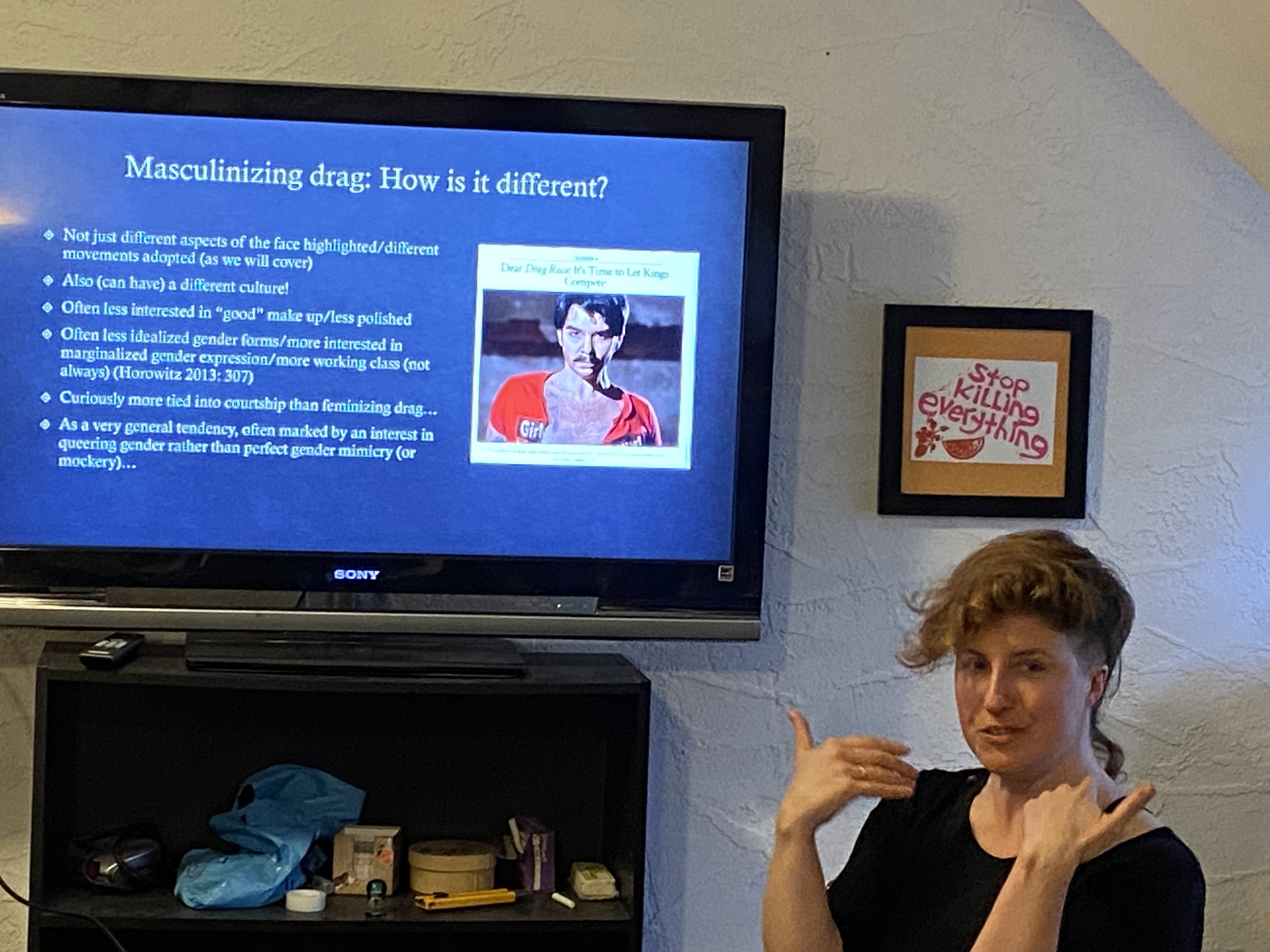 A femme looking person sits in front of a