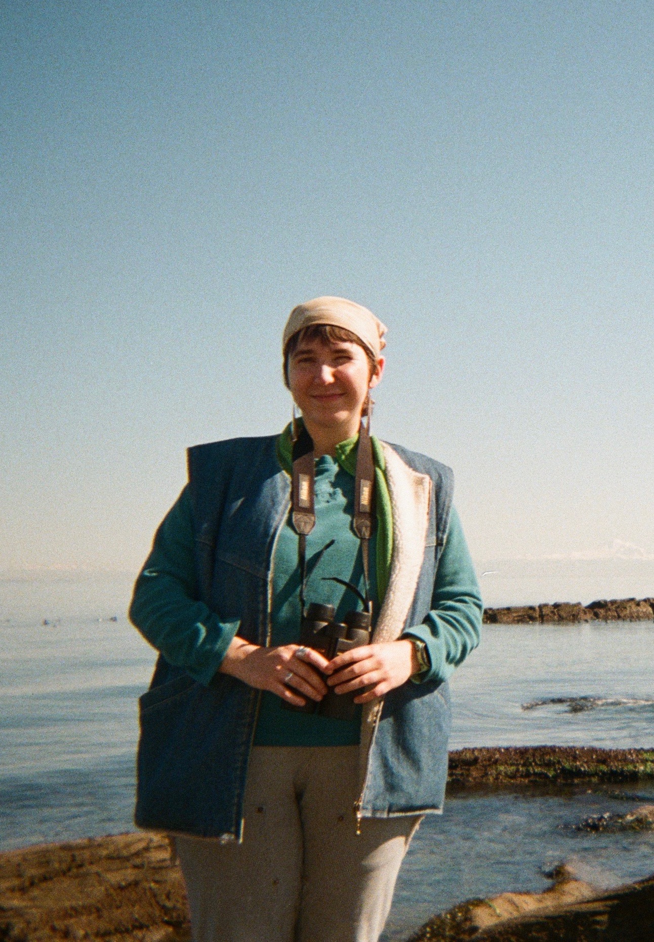 Headshot of Meghan standing in front of a large body of water