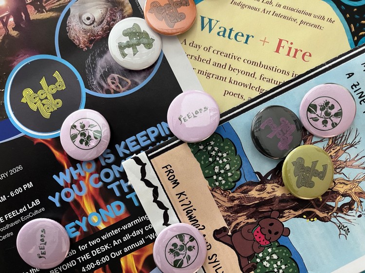A colourful jumble of FEELed Lab buttons and posters
