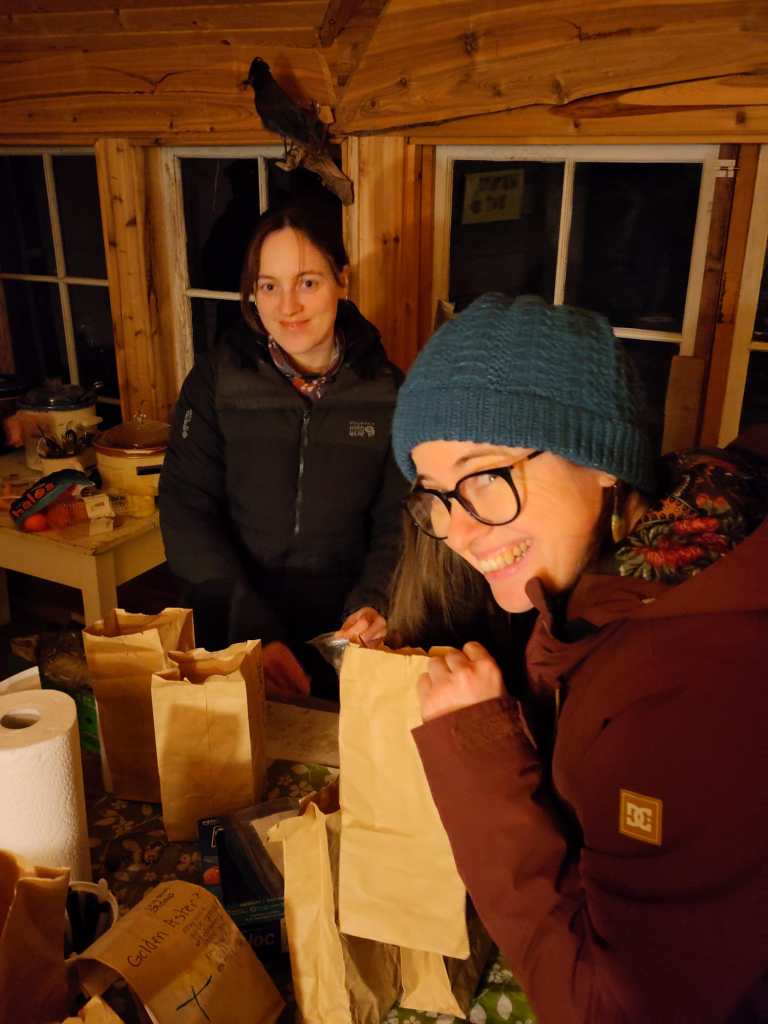 Jamie and Kaitlyn with brown paper bags full of seeds