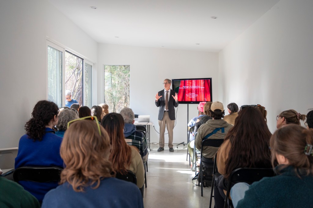Introductions to cate talk in front of a fully packed audience in Woodhaven Studio