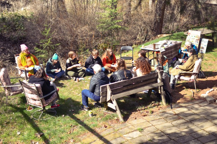 community lunch outside in a circle in the sunshine