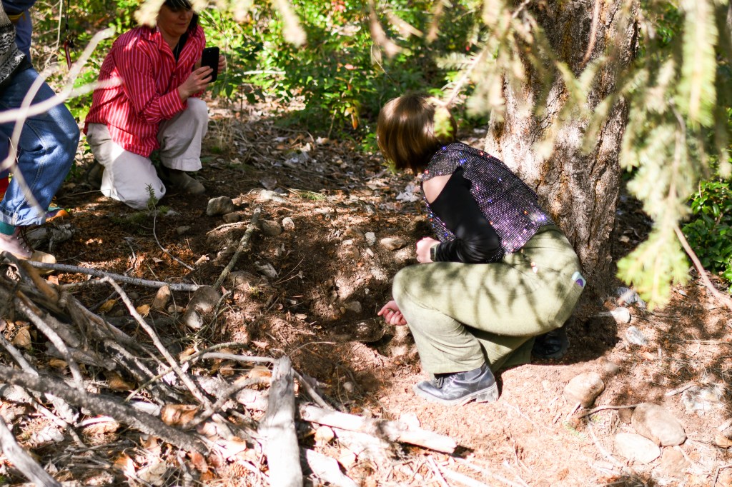 JJ unearthing the book while being filmed by Norah