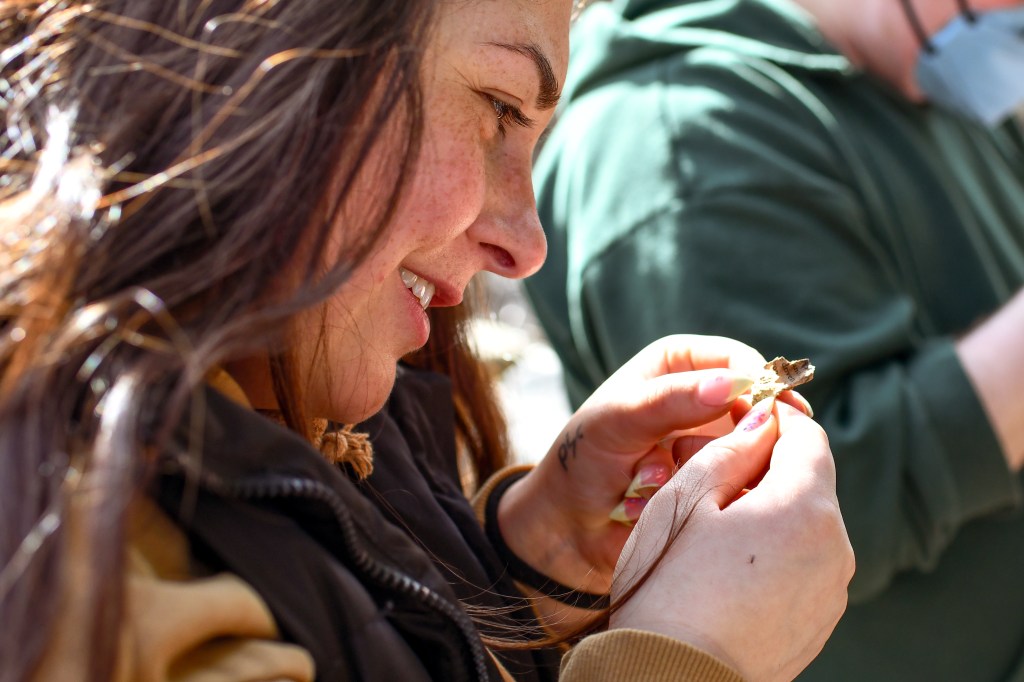 close-up of a participant reading a small scrap of remaining book