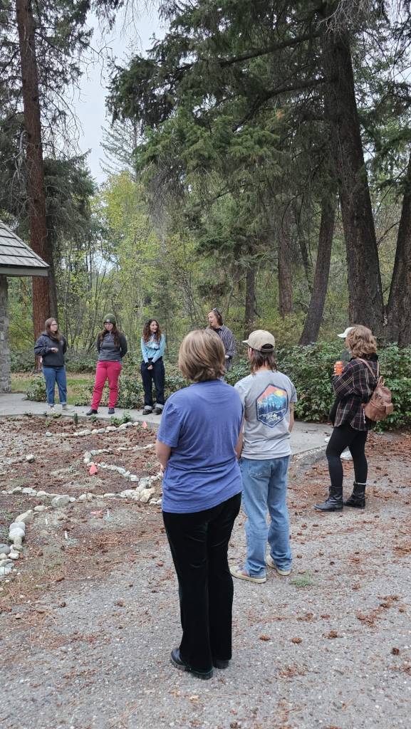 A group of people standing around the FEELed Lab garden